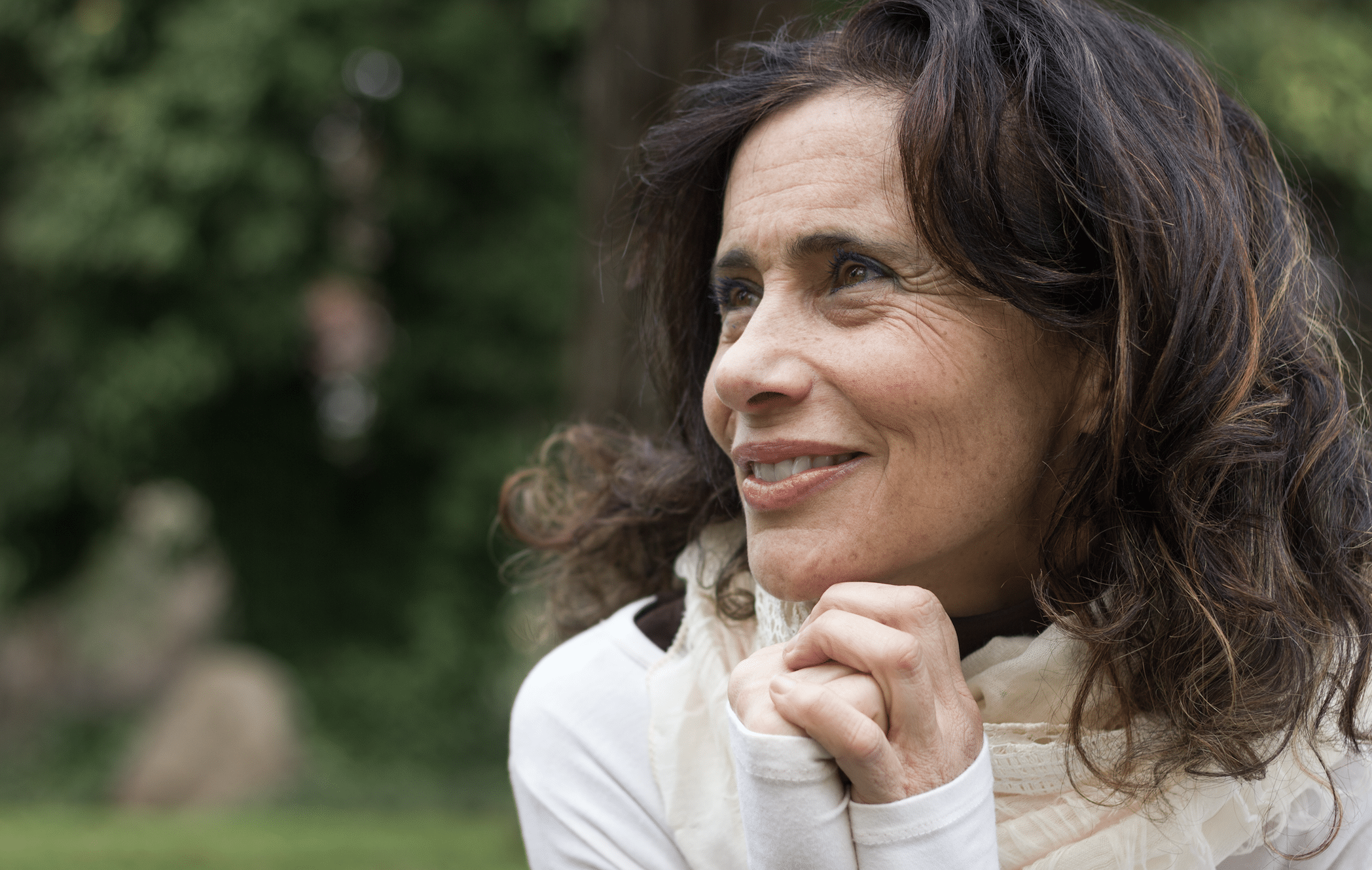 Middle aged lady smiling away from camera