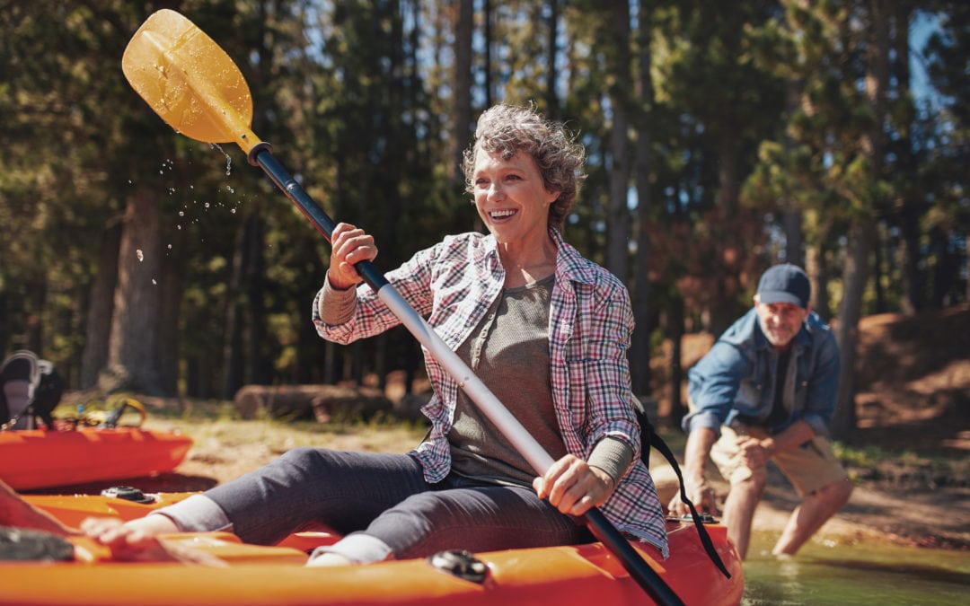 Lady having fun on kayak on a lake