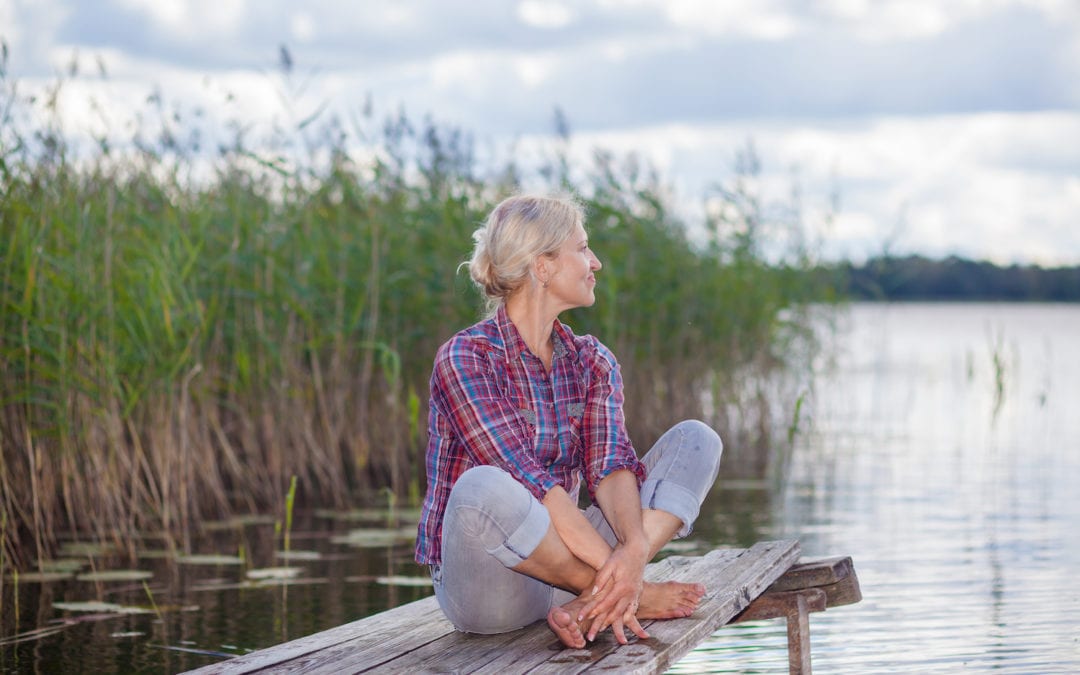 Middle aged woman relaxing on pier